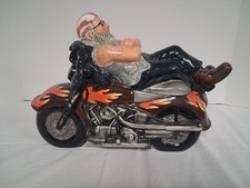 Motorcycle Rider Laying On Motorcycle Cookie Jar picture