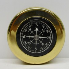 Round compass encased in brass metal cased liquid filled marked SH travel picture