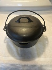 Favorite Piqua Piece Lid 8D On Top Of A “ DOT 8 “ Dutch Oven. picture
