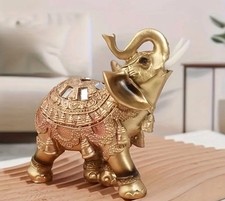 Ornate Golden Elephant Statue with Raised Trunk picture